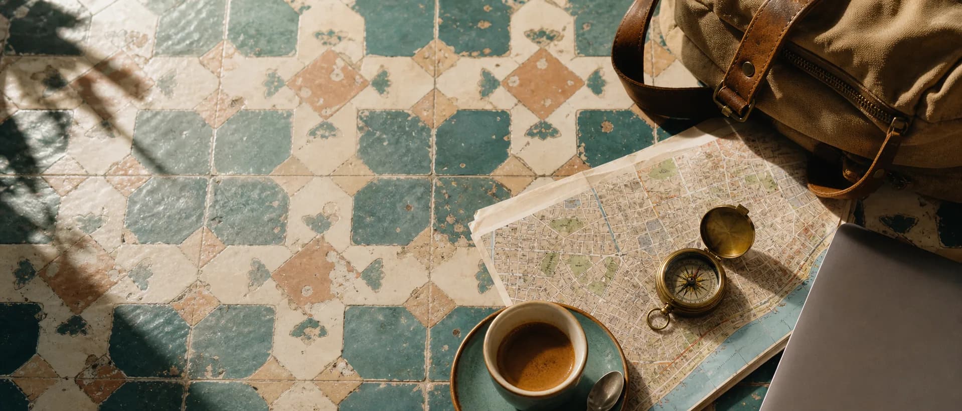 Laptop, map and coffee on a travel table