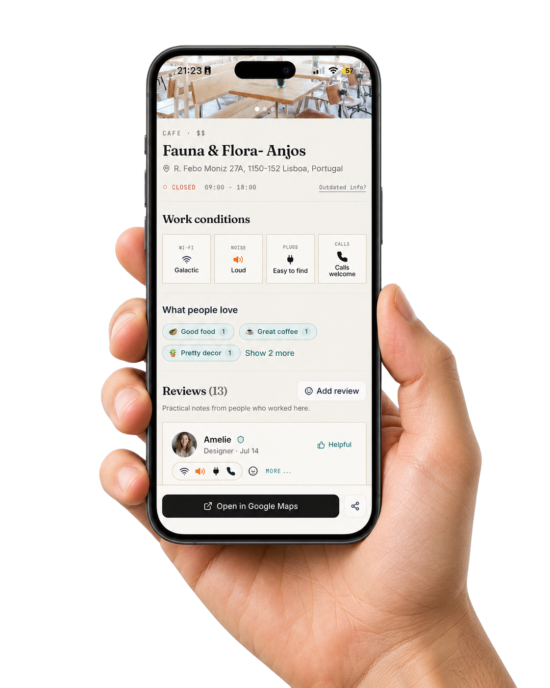 A hand holding a phone with Amelie's NomadSpots venue review open